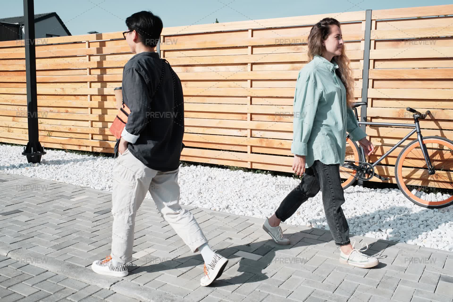 Two Women Walking Past Each Other Stock Photos Motion Array two-women-walking-past-each-other-stock-photos-motion-array