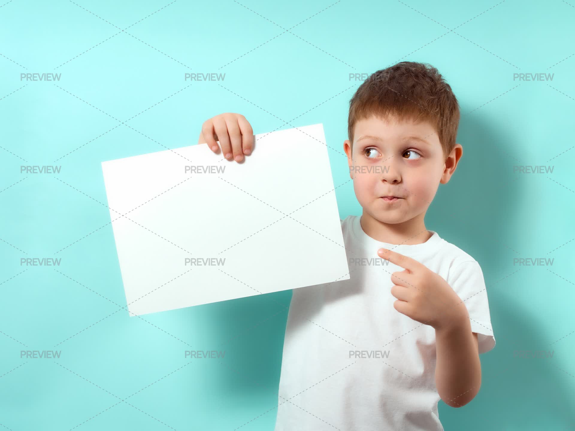 Boy Shows Finger On Blank White Sheet Stock Photos Motion Array Boy shows finger on blank white sheet stock photos motion array