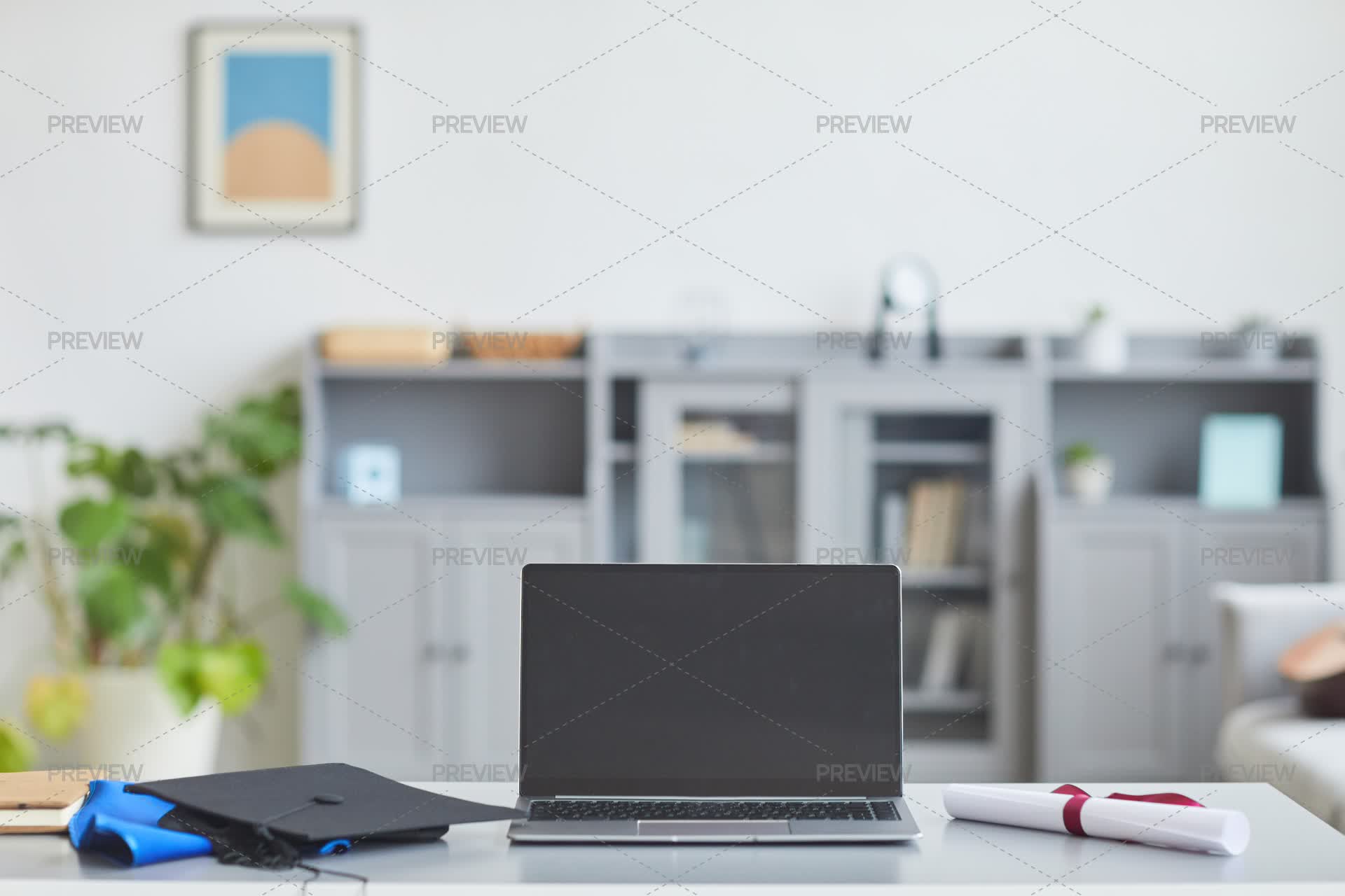 Laptop On Desk With Graduation Hat - Stock Photos | Motion Array