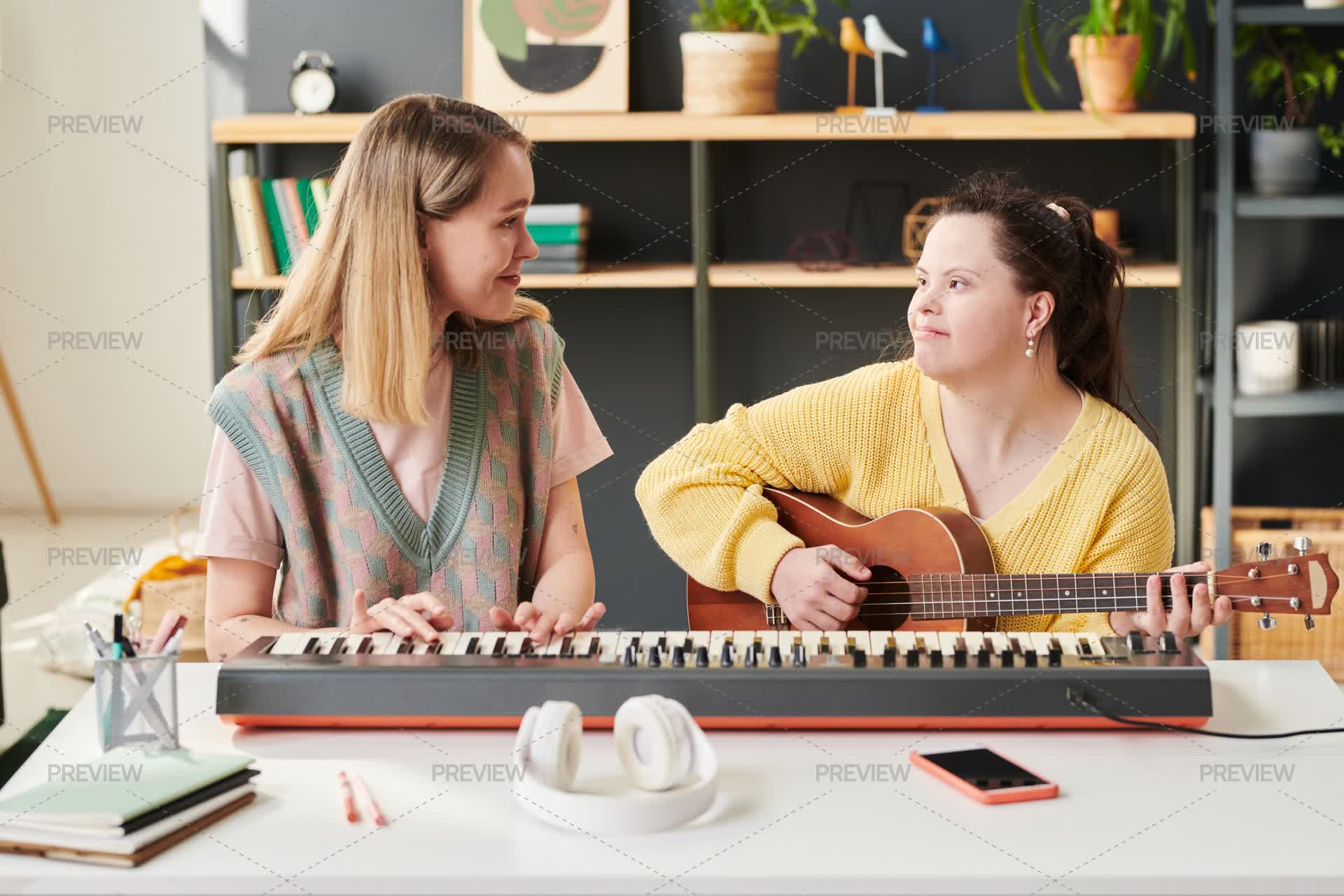Girl Playing Musical Instrument With Tutor - Stock Photos | Motion Array