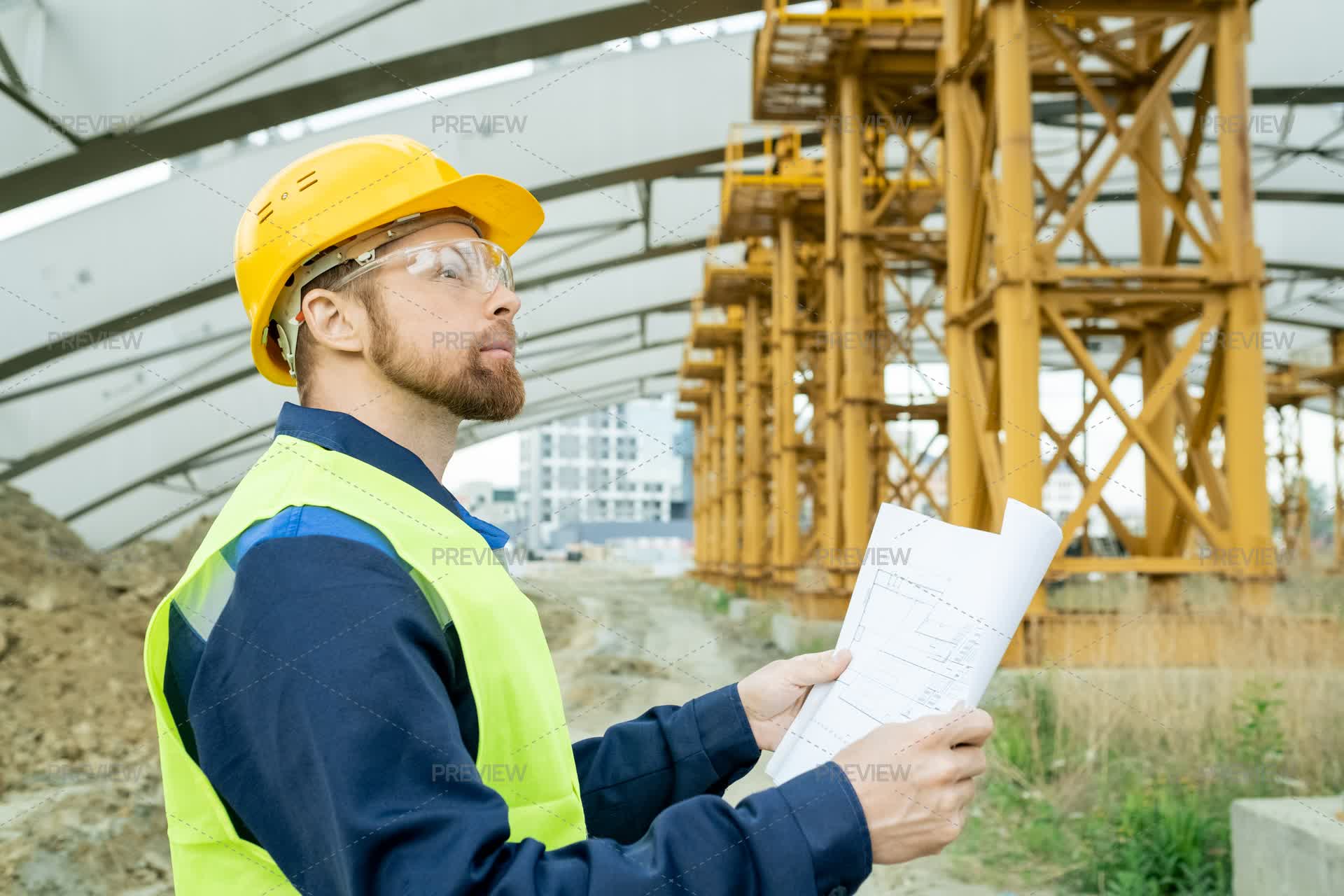 Engineer Side View Side View Of Engineer With Unrolled Blueprint - Stock Photos | Motion Array
