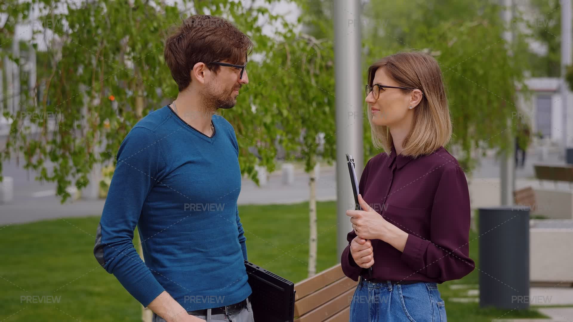 Man And Woman Talking Outside In The City Park - Stock Photos | Motion ...