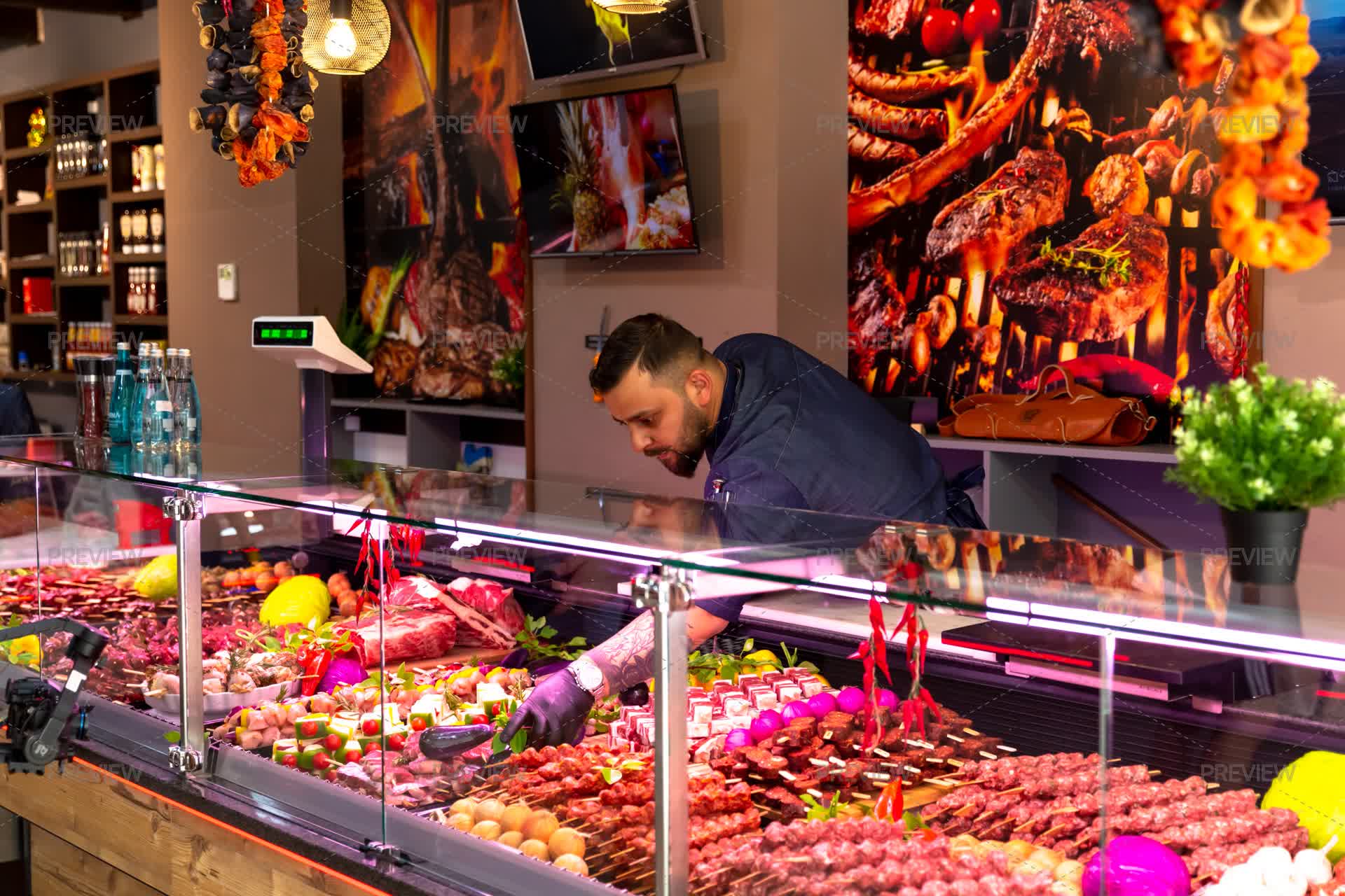 Butcher Array Butcher Arranging Meat Products In A Window Glass Cabinet - Stock ...