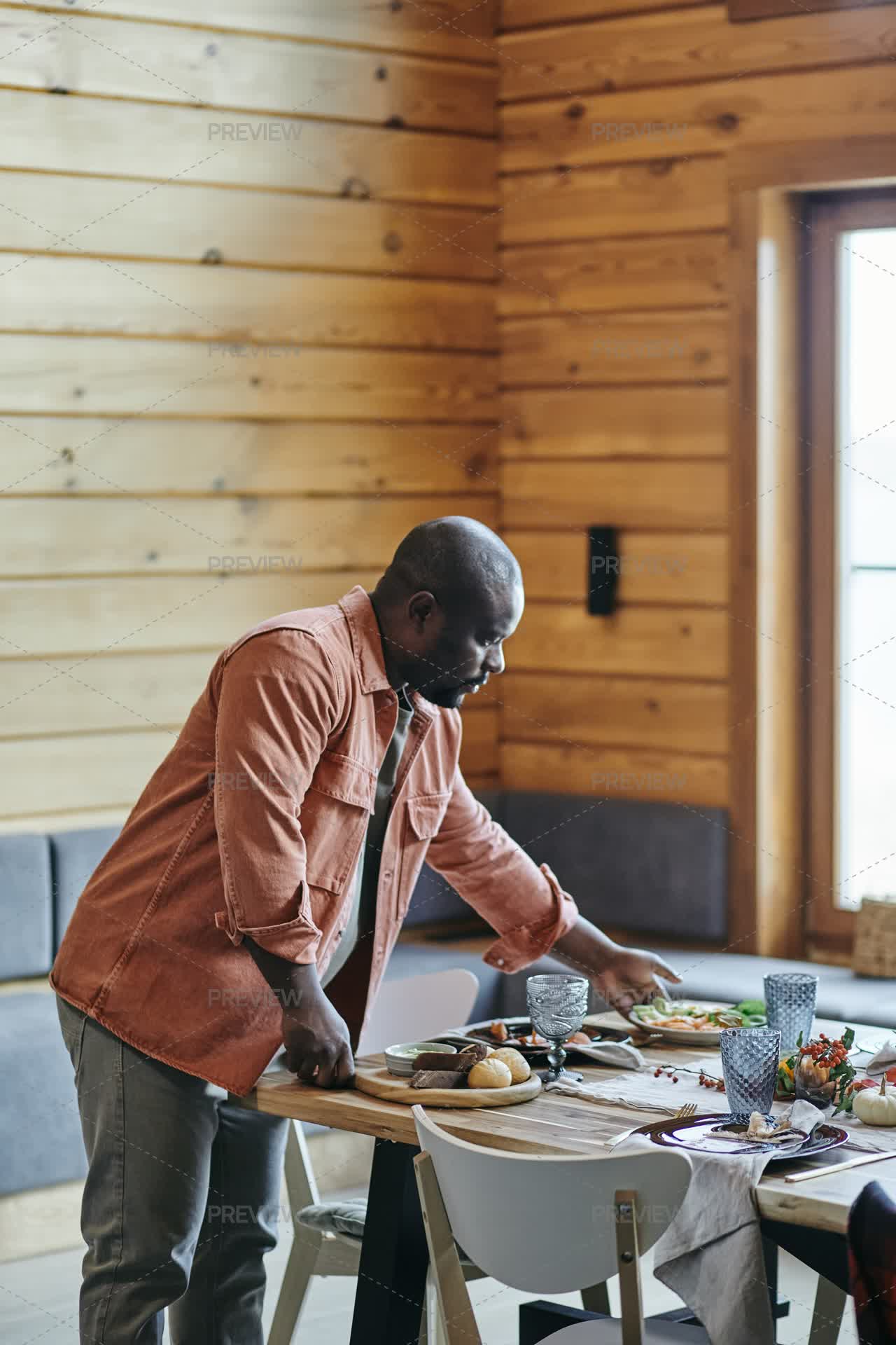 Man Putting Homemade Cooked Food On Festive Table - Stock Photos ...