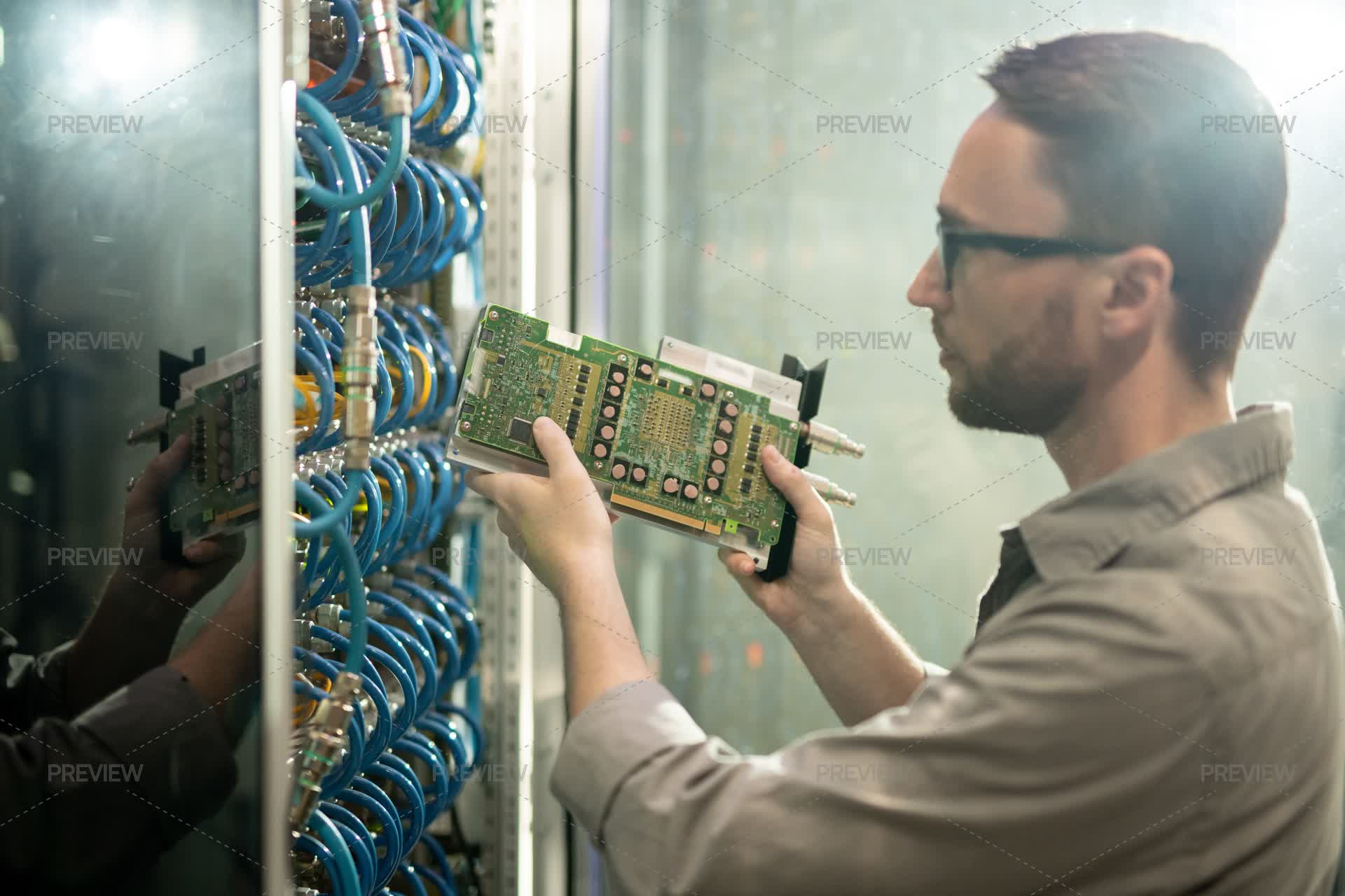 Guy Configuring Rack Installing Hardware In Rack - Stock Photos | Motion Array